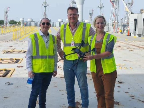 STS employees holding a drone